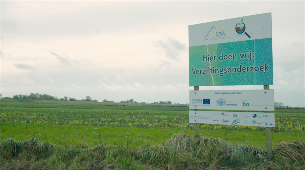 Landschap met daarin bord 'Hier doen wij: Verziltingsonderzoek'